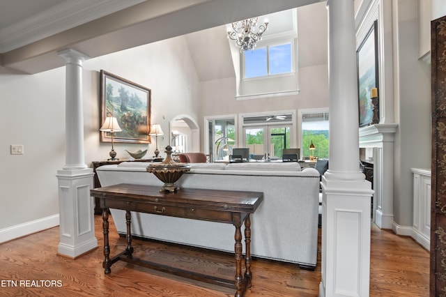 759 Indian Mountain Rd, Jellico, TN 37762 - living area featuring decorative columns, wood finished floors, a high ceiling, baseboards, and arched walkways