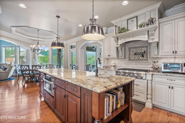 759 Indian Mountain Rd, Jellico, TN 37762 - kitchen featuring a sink, arched walkways, ornamental molding, white cabinets, and recessed lighting