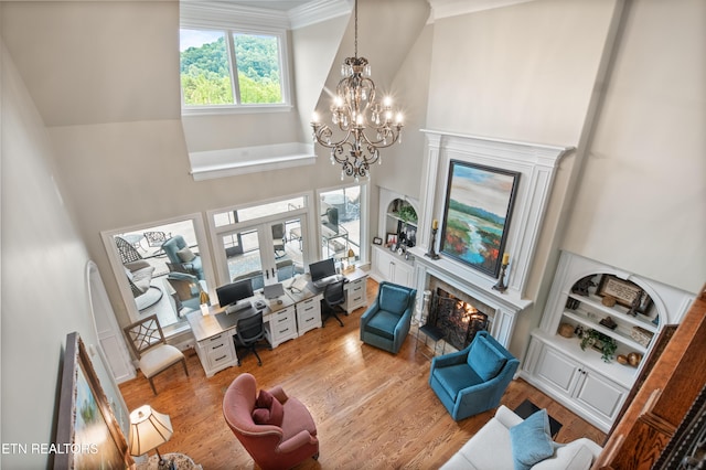 759 Indian Mountain Rd, Jellico, TN 37762 - living area with a lit fireplace, high vaulted ceiling, wood finished floors, a chandelier, and french doors