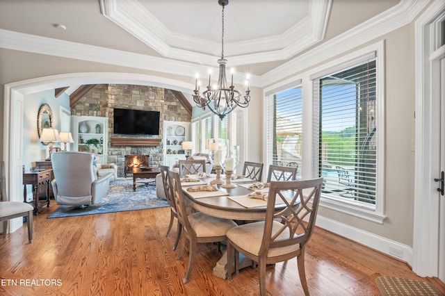 759 Indian Mountain Rd, Jellico, TN 37762 - dining space featuring a chandelier, light wood finished floors, crown molding, and a fireplace