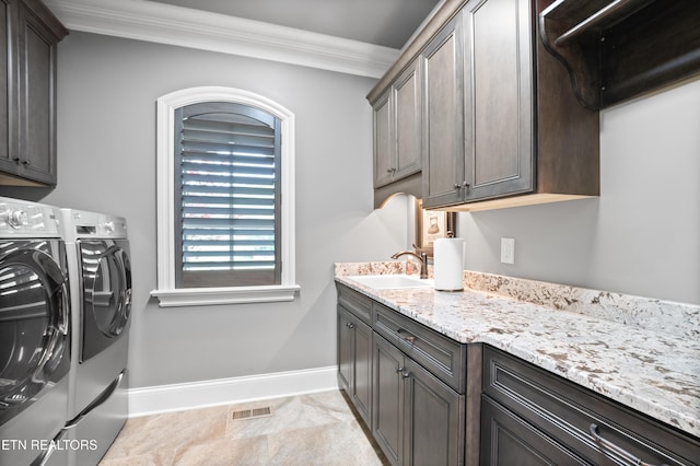 759 Indian Mountain Rd, Jellico, TN 37762 - laundry room featuring washing machine and clothes dryer, cabinet space, ornamental molding, and baseboards