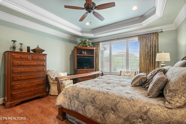 759 Indian Mountain Rd, Jellico, TN 37762 - bedroom with light wood-style flooring, crown molding, a raised ceiling, and ceiling fan
