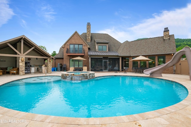 759 Indian Mountain Rd, Jellico, TN 37762 - view of swimming pool featuring a water slide, a patio area, a pool with connected hot tub, and a sunroom