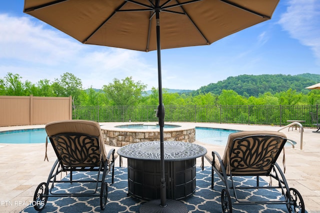 759 Indian Mountain Rd, Jellico, TN 37762 - view of pool with an outdoor hot tub, a wooded view, and a patio