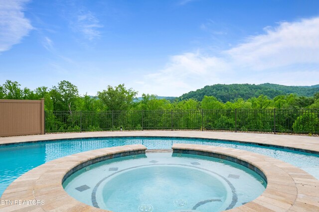 759 Indian Mountain Rd, Jellico, TN 37762 - view of pool with a view of trees and a pool with connected hot tub
