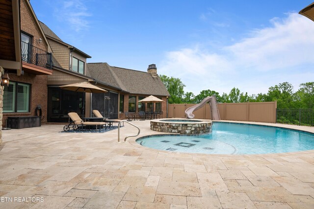 759 Indian Mountain Rd, Jellico, TN 37762 - view of swimming pool with a water slide, a patio area, and an in-ground hot tub