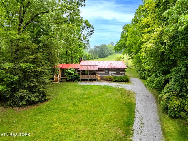 1854 Catusa Rd, Wartburg, TN 37887 - view of front of home with a chimney, metal roof, a front yard, and a wooden deck