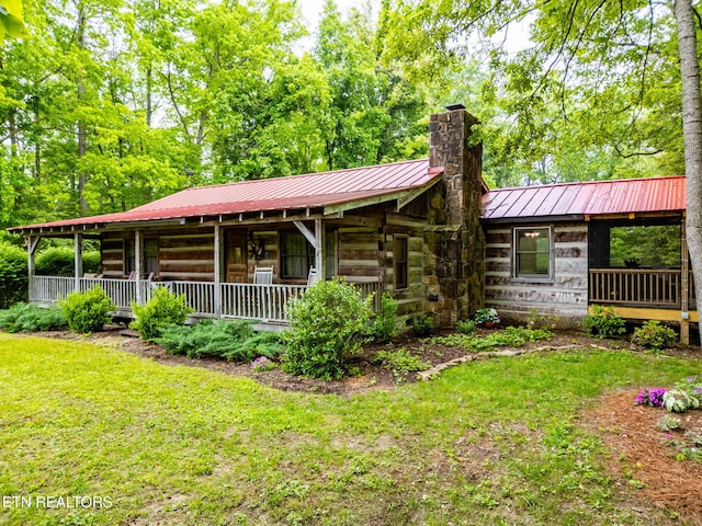 1854 Catusa Rd, Wartburg, TN 37887 - view of front of house with a chimney, a porch, metal roof, a standing seam roof, and a front lawn