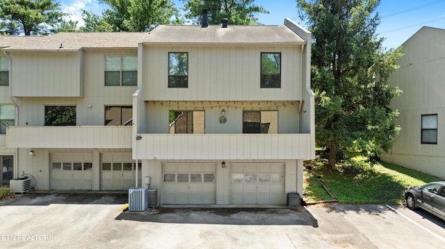8707 Olde Colony Trl Unit 17, Knoxville, TN 37923 - rear view of property with a garage, a shingled roof, a balcony, cooling unit, and asphalt driveway