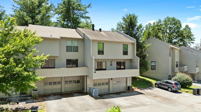 8707 Olde Colony Trl Unit 17, Knoxville, TN 37923 - view of property with an attached garage, asphalt driveway, central air condition unit, and a shingled roof