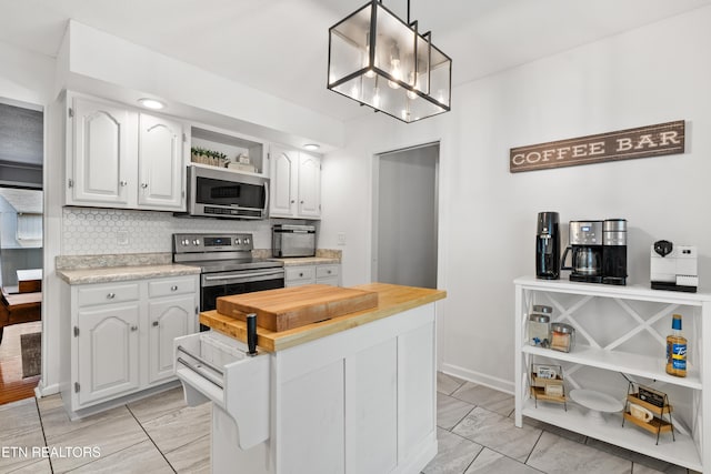 8707 Olde Colony Trl Unit 17, Knoxville, TN 37923 - kitchen with appliances with stainless steel finishes, wooden counters, white cabinetry, and tasteful backsplash