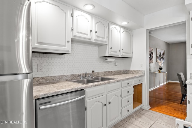 8707 Olde Colony Trl Unit 17, Knoxville, TN 37923 - kitchen with appliances with stainless steel finishes, a sink, white cabinets, backsplash, and light countertops