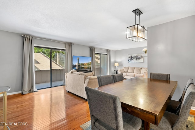 8707 Olde Colony Trl Unit 17, Knoxville, TN 37923 - dining room with light wood-type flooring, a chandelier, and baseboards