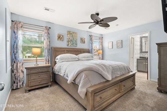 8707 Olde Colony Trl Unit 17, Knoxville, TN 37923 - bedroom with light colored carpet, ensuite bathroom, ceiling fan, and baseboards