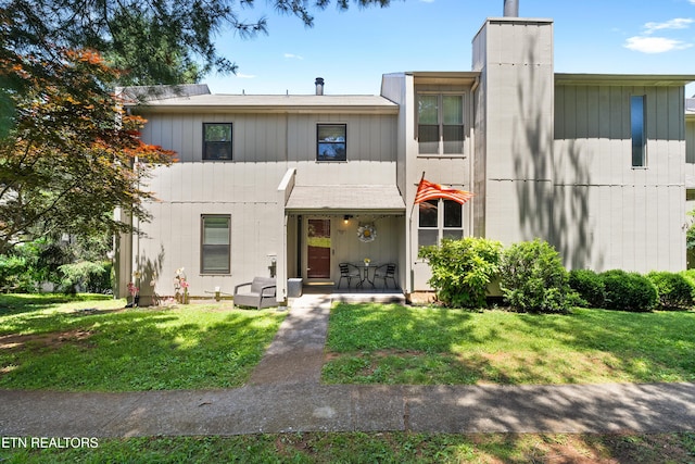 8707 Olde Colony Trl Unit 17, Knoxville, TN 37923 - view of front facade featuring a front lawn and a chimney