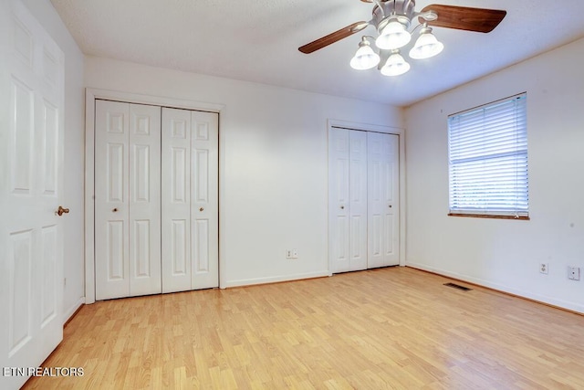 4003 Valley View Dr Unit 6, Knoxville, TN 37917 - unfurnished bedroom featuring light wood-type flooring, two closets, baseboards, and a ceiling fan