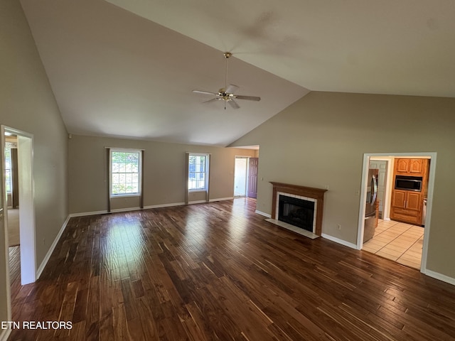 118 Toqua Club Way, Loudon, TN 37774 - unfurnished living room featuring high vaulted ceiling, a fireplace with flush hearth, wood finished floors, a ceiling fan, and baseboards