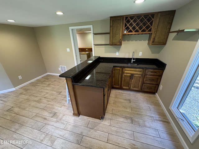 118 Toqua Club Way, Loudon, TN 37774 - kitchen with light wood finished floors, a sink, recessed lighting, dark stone countertops, and baseboards