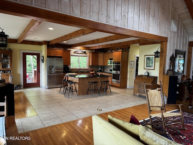 1309 Licklog Hollow Rd, Sevierville, TN 37876 - living area with light tile patterned floors, wood walls, and beam ceiling