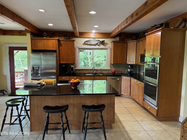 1309 Licklog Hollow Rd, Sevierville, TN 37876 - kitchen with stainless steel appliances, beam ceiling, tasteful backsplash, healthy amount of natural light, and a sink