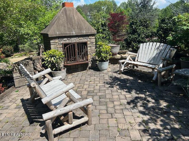 1309 Licklog Hollow Rd, Sevierville, TN 37876 - view of patio / terrace with an outdoor stone fireplace
