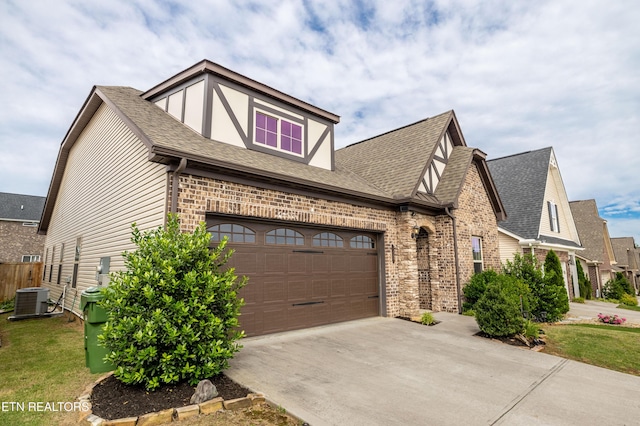 1227 Branch Creek Ln, Maryville, TN 37801 - view of front of house featuring a shingled roof, driveway, brick siding, and central AC