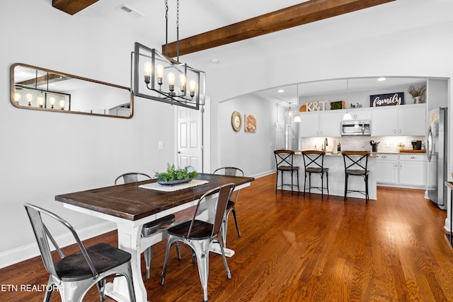 1227 Branch Creek Ln, Maryville, TN 37801 - dining area featuring beamed ceiling, baseboards, a chandelier, dark wood-style floors, and arched walkways