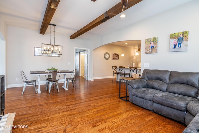 1227 Branch Creek Ln, Maryville, TN 37801 - living room with arched walkways, wood finished floors, a chandelier, baseboards, and beamed ceiling
