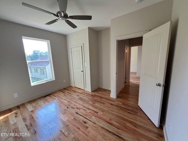 110 Stone Rd, Knoxville, TN 37920 - unfurnished bedroom with wood finished floors, baseboards, and ceiling fan