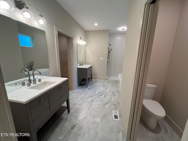 110 Stone Rd, Knoxville, TN 37920 - full bathroom with tiled shower, toilet, vanity, marble look tiles, and a walk in closet