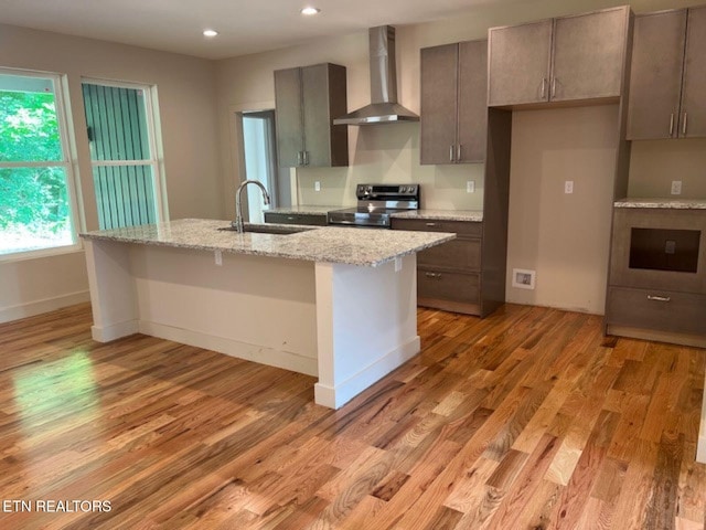 110 Stone Rd, Knoxville, TN 37920 - kitchen featuring wall chimney range hood, a sink, stainless steel range with electric stovetop, a center island with sink, and recessed lighting