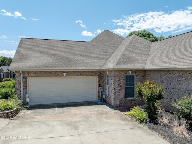 210 Oologila Pl, Loudon, TN 37774 - view of front of property with a shingled roof, a garage, concrete driveway, and brick siding