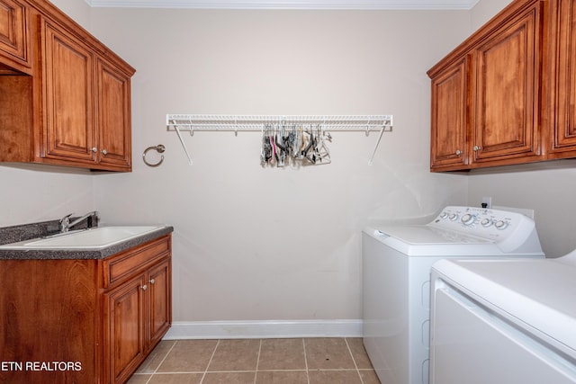 210 Oologila Pl, Loudon, TN 37774 - laundry room featuring washing machine and clothes dryer, cabinet space, light tile patterned floors, and baseboards