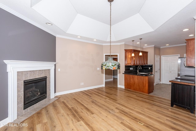 210 Oologila Pl, Loudon, TN 37774 - unfurnished living room with light wood finished floors, a sink, a fireplace, recessed lighting, and ornamental molding