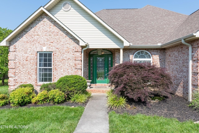 210 Oologila Pl, Loudon, TN 37774 - view of exterior entry with a shingled roof and brick siding