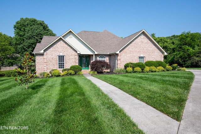 210 Oologila Pl, Loudon, TN 37774 - view of front of house with brick siding, a front lawn, and roof with shingles