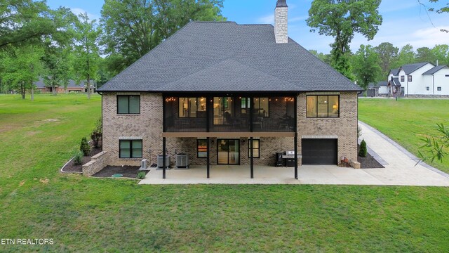 708 Lakeside Ct, Dandridge, TN 37725 - rear view of property with brick siding, a sunroom, a chimney, a lawn, and a patio area