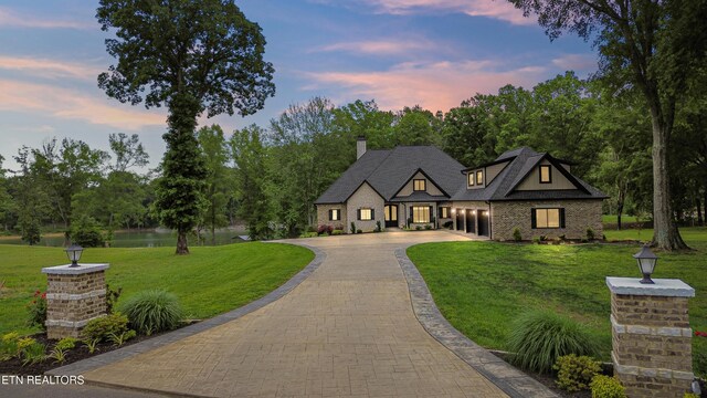 708 Lakeside Ct, Dandridge, TN 37725 - view of front of home featuring curved driveway, a lawn, and a chimney