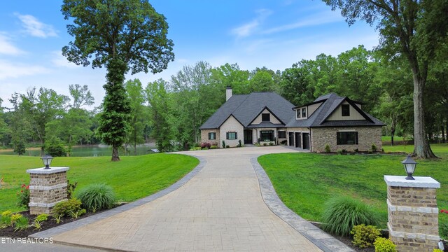 708 Lakeside Ct, Dandridge, TN 37725 - view of front of home featuring asphalt driveway, a front yard, a chimney, and brick siding