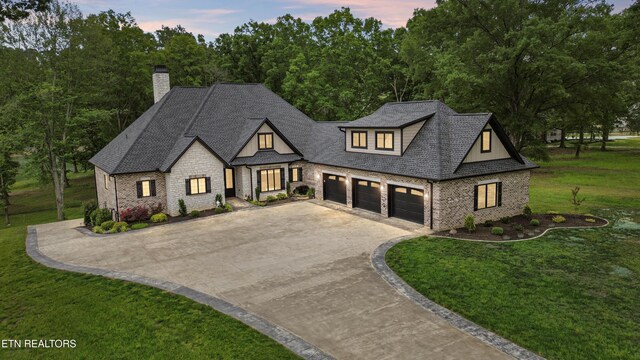708 Lakeside Ct, Dandridge, TN 37725 - view of front of home featuring driveway, a front lawn, a chimney, a shingled roof, and stone siding
