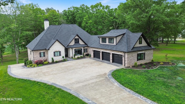 708 Lakeside Ct, Dandridge, TN 37725 - view of front of home with concrete driveway, a front yard, stone siding, and a chimney