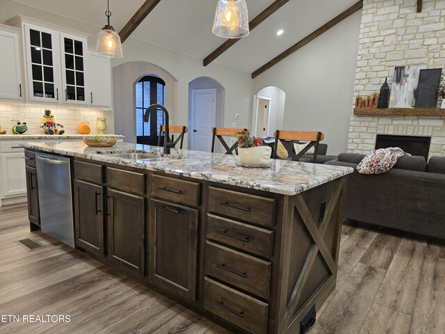 708 Lakeside Ct, Dandridge, TN 37725 - kitchen with stainless steel dishwasher, a sink, arched walkways, wood finished floors, and recessed lighting
