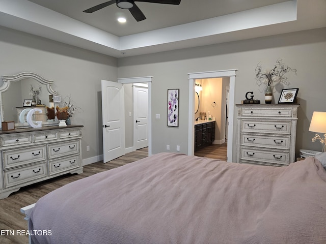 708 Lakeside Ct, Dandridge, TN 37725 - bedroom with dark wood-type flooring, ensuite bath, a tray ceiling, baseboards, and ceiling fan