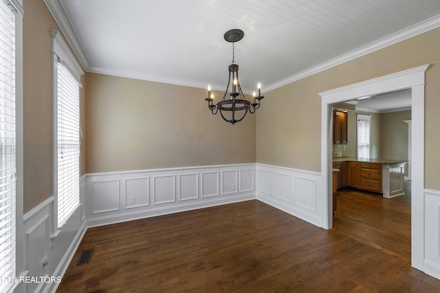 4914 Circle Rd, Corryton, TN 37721 - empty room featuring a chandelier, wainscoting, dark wood-type flooring, crown molding, and a decorative wall