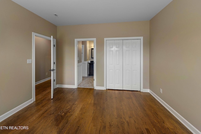 4914 Circle Rd, Corryton, TN 37721 - unfurnished bedroom featuring dark wood finished floors, a closet, baseboards, and ensuite bath