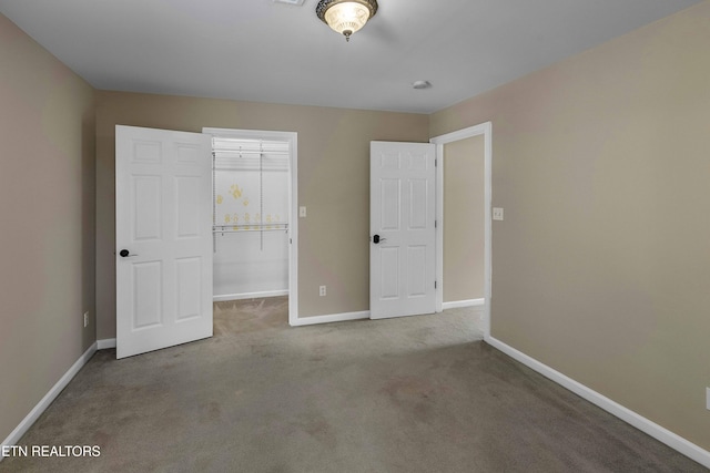 4914 Circle Rd, Corryton, TN 37721 - unfurnished bedroom featuring a walk in closet, carpet floors, baseboards, and a closet