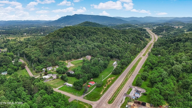 4914 Circle Rd, Corryton, TN 37721 - aerial overview of property's location with a forest, a mountain backdrop, and a main thoroughfare