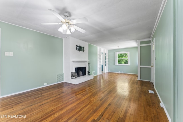 104 Carlisle Ln, Oak Ridge, TN 37830 - unfurnished living room featuring hardwood / wood-style floors, a brick fireplace, ceiling fan, and baseboards