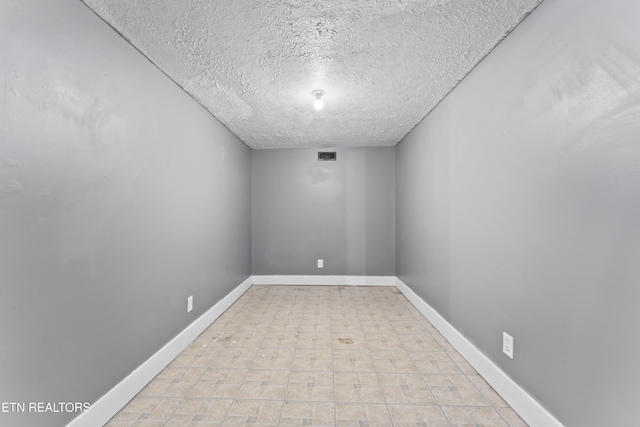 104 Carlisle Ln, Oak Ridge, TN 37830 - spare room with a textured ceiling and baseboards