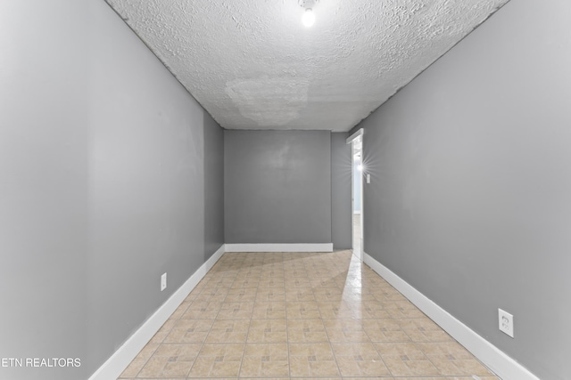 104 Carlisle Ln, Oak Ridge, TN 37830 - spare room with a textured ceiling and baseboards